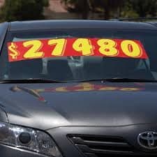 Giant stick-on price numbers on a windshield